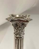 A pair of electroplated Corinthian silver candlesticks, 20th century