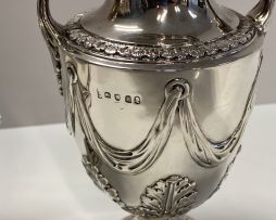 A George III silver two-handled urns and covers, maker's marks indistinct, London, 1770