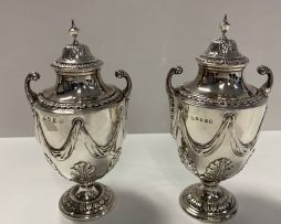 A George III silver two-handled urns and covers, maker's marks indistinct, London, 1770
