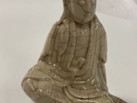 A Chinese creamy white-glazed figure of Guanyin, Qing Dynasty, 18th century