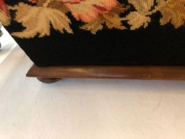 A tapestry upholstered and mahogany ottoman