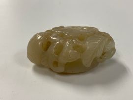 A Chinese celadon jade carving of a lily pod, Qing Dynasty, 19th century