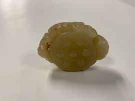 A Chinese celadon jade carving of a lily pod, Qing Dynasty, 19th century