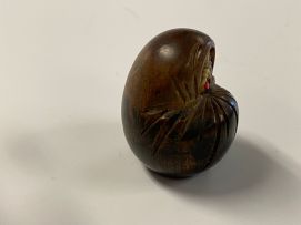 A Japanese wood carving of a Daruma, Meiji period, 1868-1912