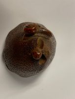 A Japanese wood netsuke of a lily pod, Meiji period, 1868-1912