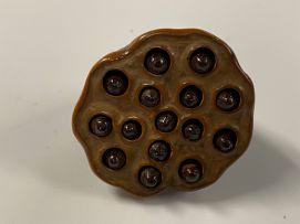 A Japanese wood netsuke of a lily pod, Meiji period, 1868-1912