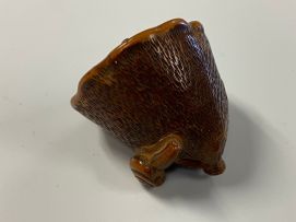 A Japanese wood netsuke of a lily pod, Meiji period, 1868-1912