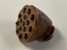 A Japanese wood netsuke of a lily pod, Meiji period, 1868-1912