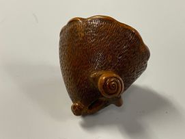 A Japanese wood netsuke of a lily pod, Meiji period, 1868-1912