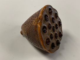 A Japanese wood netsuke of a lily pod, Meiji period, 1868-1912