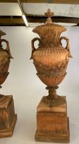 A pair of terracotta composition two-handled garden urns-on-stands and covers, mid 20th century