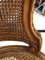 A Louis XV style caned and walnut two-seater settee