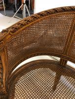 A Louis XV style caned and walnut two-seater settee