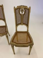 A pair of Louis XV style painted and caned side chairs