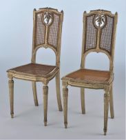 A pair of Louis XV style painted and caned side chairs