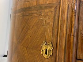 A Louis XVI style demi-lune parquetry and gilt-metal-mounted cabinet