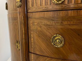A Louis XVI style demi-lune parquetry and gilt-metal-mounted cabinet