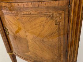 A Louis XVI style demi-lune parquetry and gilt-metal-mounted cabinet