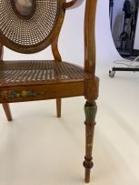 A pair of George III style satinwood and painted armchairs