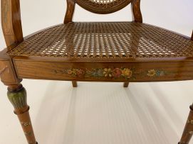 A pair of George III style satinwood and painted armchairs