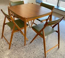 An Italian walnut poker table and four walnut and leather folding chairs designed by Gio Ponti for Fratelli Reguitti, 1960s