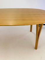 A laminated beech Ellipse dining table designed in 1968 by Piet Hein for Fritz Hansen