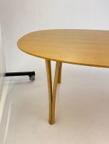 A laminated beech Ellipse dining table designed in 1968 by Piet Hein for Fritz Hansen