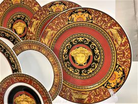 A Rosenthal Versace red, gilt and black 'Medusa' pattern dinner service designed by Paul Wunderlich, 20th century