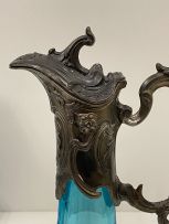 A pair of patinated spelter-mounted turquoise glass claret jugs, late 19th century