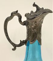 A pair of patinated spelter-mounted turquoise glass claret jugs, late 19th century