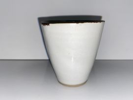Lucie Rie (1902-1995) A pair of cream glazed stoneware coffee cups and saucers
