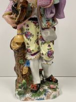 A pair of French porcelain figures of a hurdy-gurdy player and his companion, Paris, Jules Viallate, late 19th century