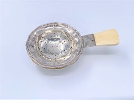 An Austrian silver tea strainer and stand, maker's initials FT, .800 sterling, 1925-